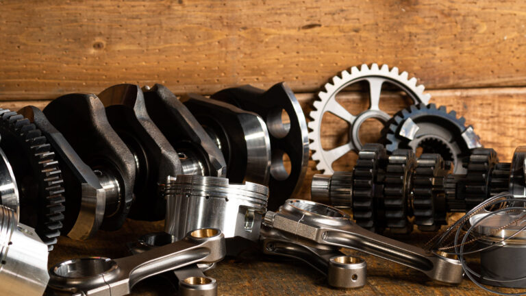 table with engine parts on a wood background