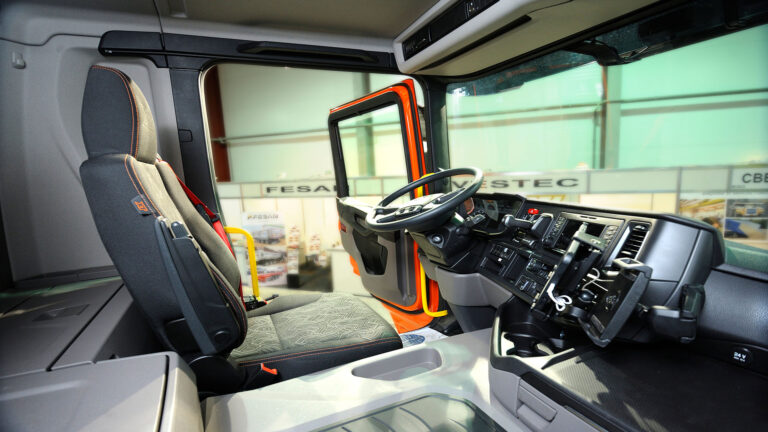 nside of a heavy equipment cab with chair and steering wheel